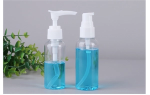 Detail showing two clear plastic pump bottles with blue liquid and white spray heads