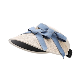 Foldable beige straw sun hat for women with blue denim bow and black adjustable strap