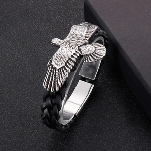 Detail of men's eagle leather bracelet with woven black cord and magnetic metal clasp