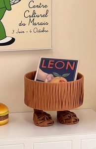 Detail showing the woven texture and unique feet design of this creative storage basket