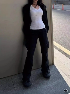 Women's slim white vest and black cargo pants with oversized jacket street style outfit