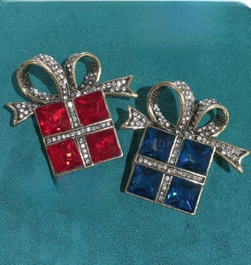 Detail of red and blue gift box brooches with crystals and sparkling rhinestones