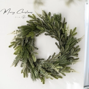Forest-style Christmas PE wreath hanging on a white wall for festive home decor