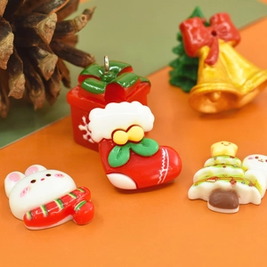 Detailed macro view of 5 assorted Christmas resin charms including tree, sock, and bunny