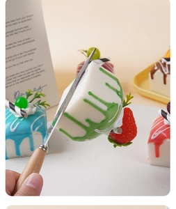Detailed macro view of realistic square fruit cream cake models being sliced with a knife
