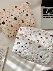 Quilted cotton cosmetic bag with cute cartoon prints in a cozy lifestyle setting