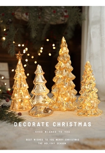 Close-up of glass LED Christmas trees in warm gold and mercury silver holiday decor