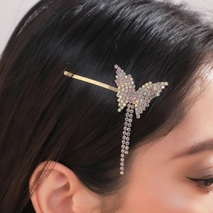 Elegant gold butterfly hair claw with sparkling rhinestones and long tassel pendants
