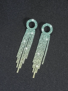 Detail view of mint green rhinestone long tassel earrings with polished round links