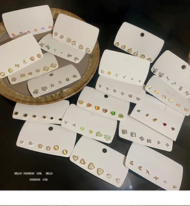 Detailed set of assorted stud earrings featuring hearts, bows, and geometric designs