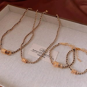 Vintage gold clover cylinder necklace and bracelet set with sparkling zircon details