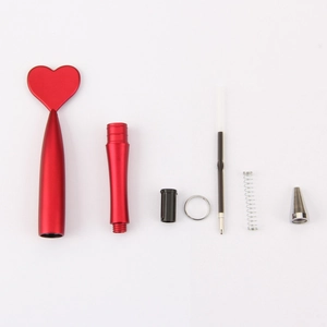 Exploded view of a red heart-shaped pen showing metal components and assembly parts