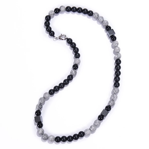 Detailed view of 8mm tiger eye stone beads and black magnetic cubes with lobster clasp