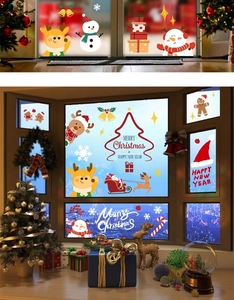 Close-up of colorful reindeer and snowman stickers on a festive window glass surface