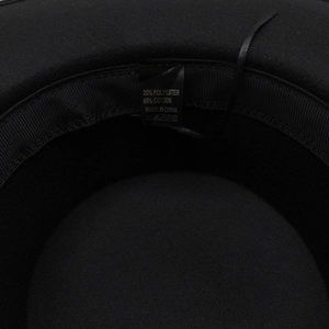 Detailed view of hat interior featuring sweatband and fabric care label with material specs
