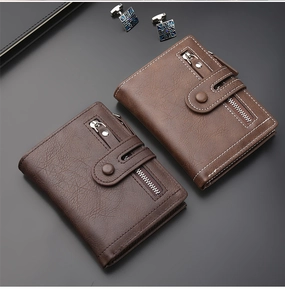 Detailed view of brown leather vertical wallets with zipper pocket and snap button closure