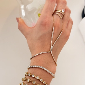 Chic layered gold and silver bracelet set with sparkling diamonds and a ring attachment