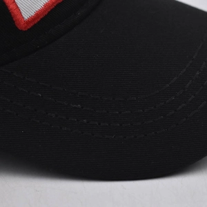 Detailed close-up of high-quality cotton twill black baseball cap with red white embroidery