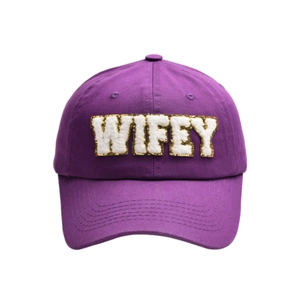 Close-up of WIFEY letter embroidery with gold glitter on purple cotton baseball cap