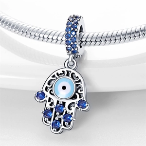 Silver Hamsa Hand charm with blue zircon evil eye beads on a beaded bracelet