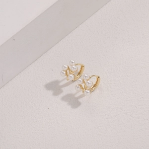 Detail of 14K gold plated branch earrings with elegant small white pearl clusters