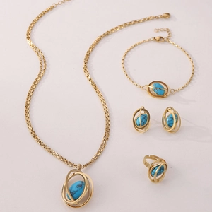Detailed set of golden necklace, bracelet, earrings and ring with turquoise gemstones