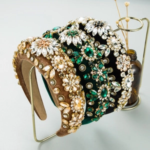 Detail of luxury padded velvet headbands with hand-sewn crystals on a display stand