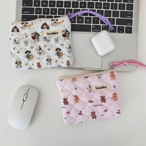 Detail of floral quilted mini storage bags with zipper closure and portable wrist straps