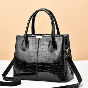 Glossy black faux crocodile pattern tote bag with gold hardware and wide shoulder strap
