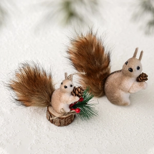 Charming pair of brown plush squirrel ornaments for Christmas tree decor in snowy scene