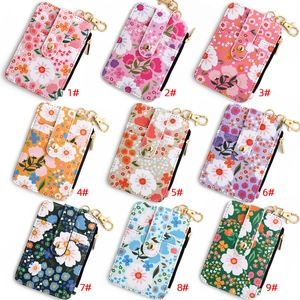 Floral print card holder wallets in nine colors with metal hooks and zipper detail