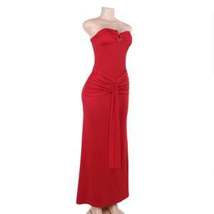 Detail of red strapless maxi dress with slimming pleated waist and elastic fabric texture