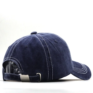 Detail view of navy washed cotton baseball cap featuring silver metal adjustable buckle