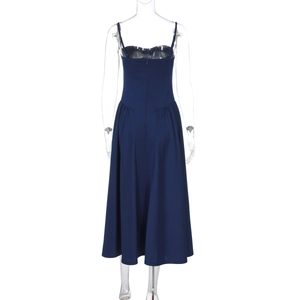 Detail view of the back of a navy blue midi slip dress with thin spaghetti straps