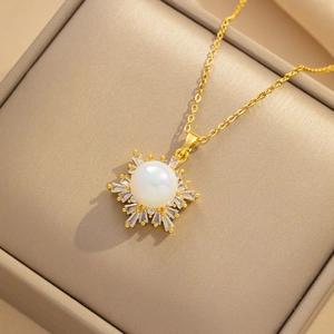 18K gold snowflake necklace with mermaid pearl and cubic zirconia in a jewelry box