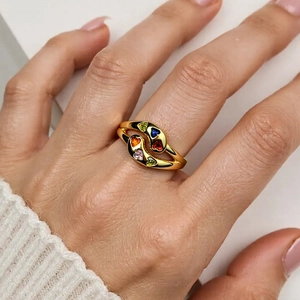 Adjustable gold snake ring with colorful heart crystals worn on model's hand