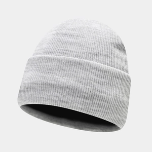 Detailed macro view of the light grey ribbed knit beanie texture and warm folded cuff design