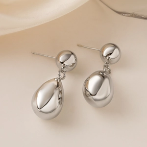 Minimalist silver spherical geometric drop earrings with high polish metallic finish