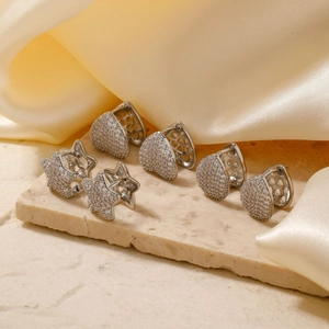 Detail of silver star, heart, and teardrop hoop earrings with pave zircon settings