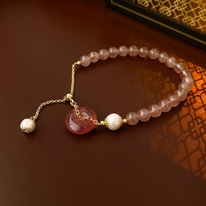 Macro detail of strawberry quartz beads and white pearl on vintage floral bracelet
