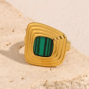 Macro detail of a 18K gold-plated ring featuring a green striped trapezoid acrylic stone