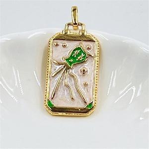 Macro detail of gold Aquarius tarot pendant with green silhouette and pink enamel inlay