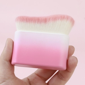 Close-up of wavy pink gradient foundation brush with soft synthetic bristles for makeup