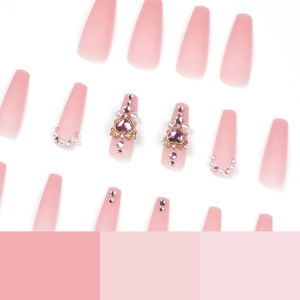 Pink press-on nails with 3D heart gems and pearls in long ballerina coffin shape
