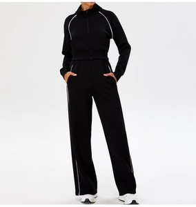 Detail of black sports set with stand collar zipper jacket and striped wide-leg pants