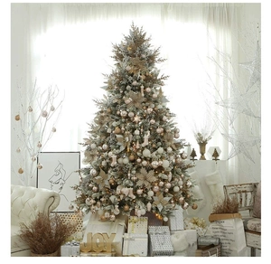 Close-up of champagne gold Christmas tree ornaments with star and gift box decorations