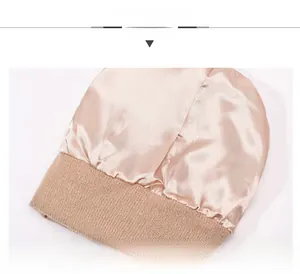 Detail display of the champagne satin lining and brown knit texture on the beanie