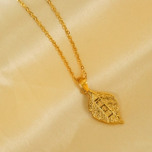 Macro shot of gold leaf pendant with Chinese characters on luxury silk background