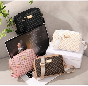Four vintage geometric crossbody bags in black, white, pink, and brown with gold hardware