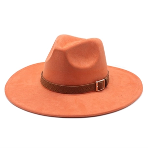 Detail view of orange suede wide brim fedora with brown braided leather band and metal buckle